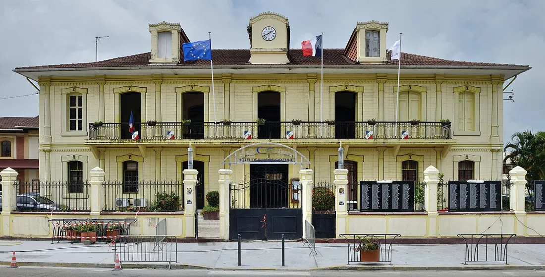 Façade de l'hôtel de ville de Cayenne, bâtiment colonial classé, pavoisé des drapeaux français et européen